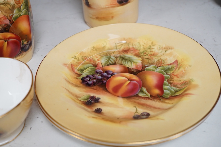 A collection of Aynsley Orchard Gold wares including a timepiece, vases, etc. tallest 23cm